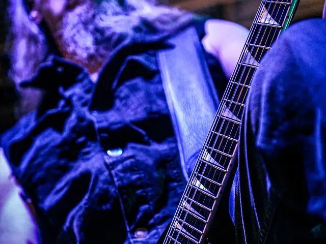 Guitarist with a V-shaped guitar, head tilted back