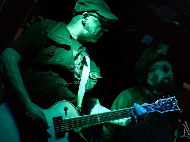 Guitarist with a white Les Paul, vocalist behind