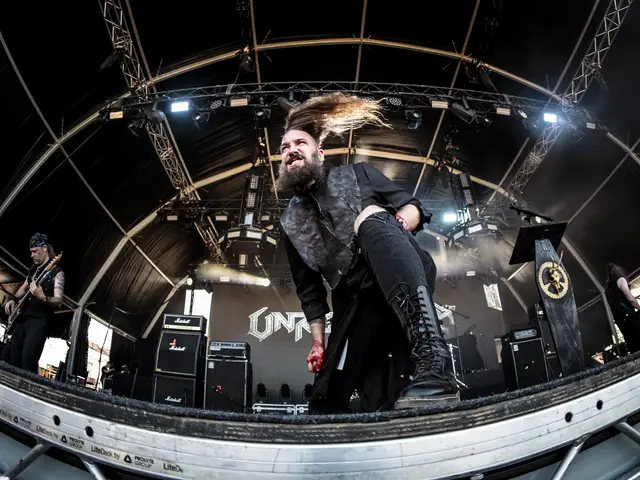 Vocalist lunging toward the lens, hair flying, on the main stage